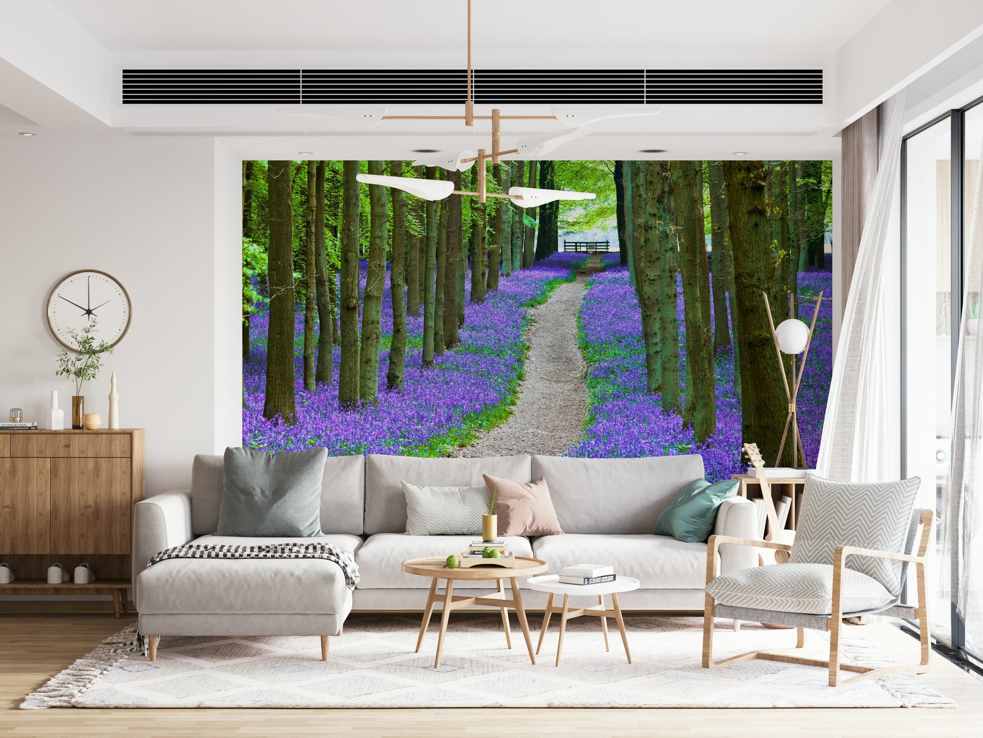 Nature wallpaper with tall forest trees and a carpet of purple-blue bluebells along a peaceful path.