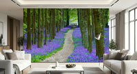 Bluebell Trail wallpaper featuring a forest pathway lined with vibrant purple-blue wildflowers.