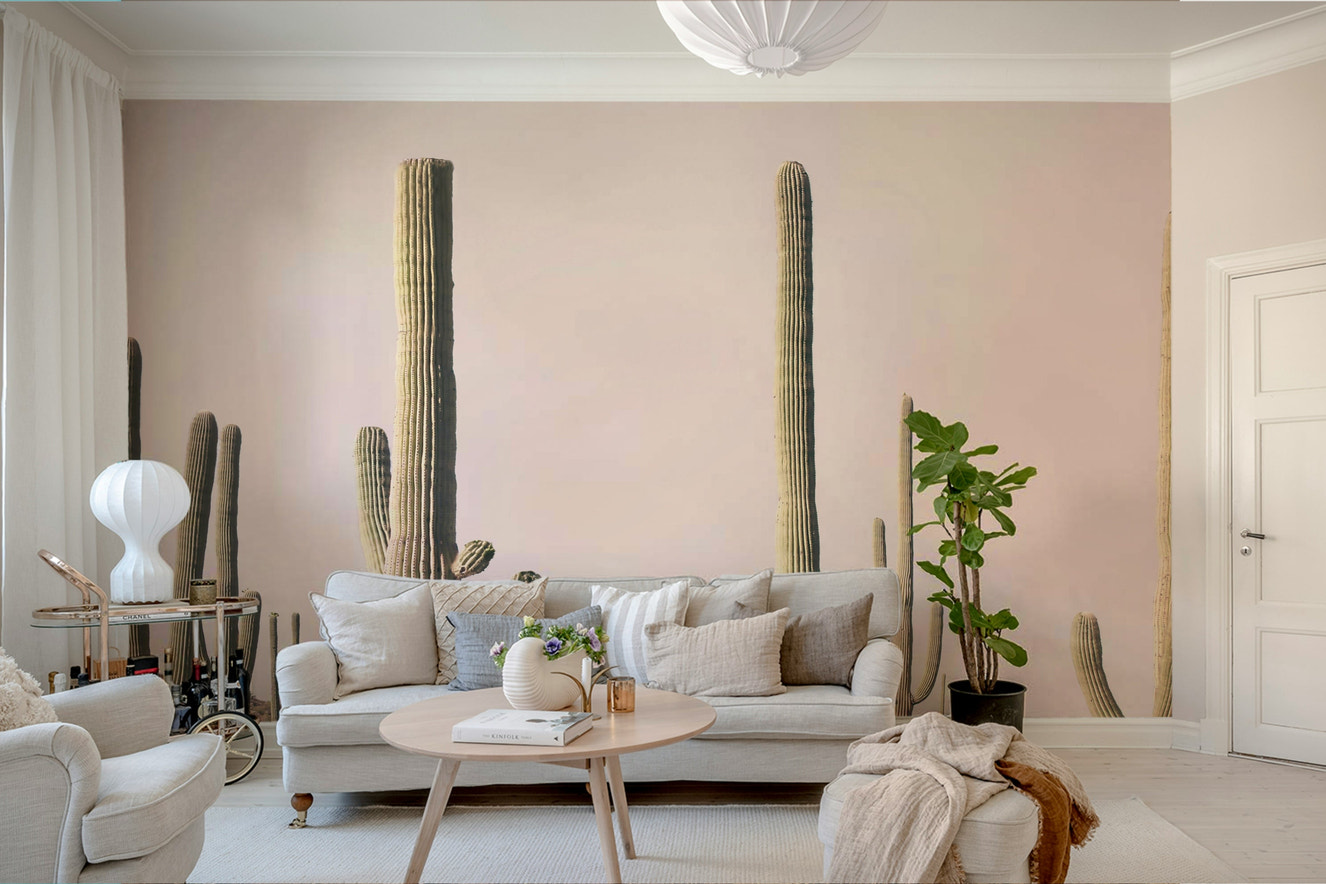 Desert-inspired mural with soft pink cactus silhouettes

