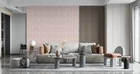A blush pink floral wallpaper featuring delicate spring blooms arranged in a soft, calming pattern.
