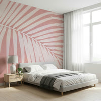 An artistic soft pink palm mural on minimalist wallpaper.

