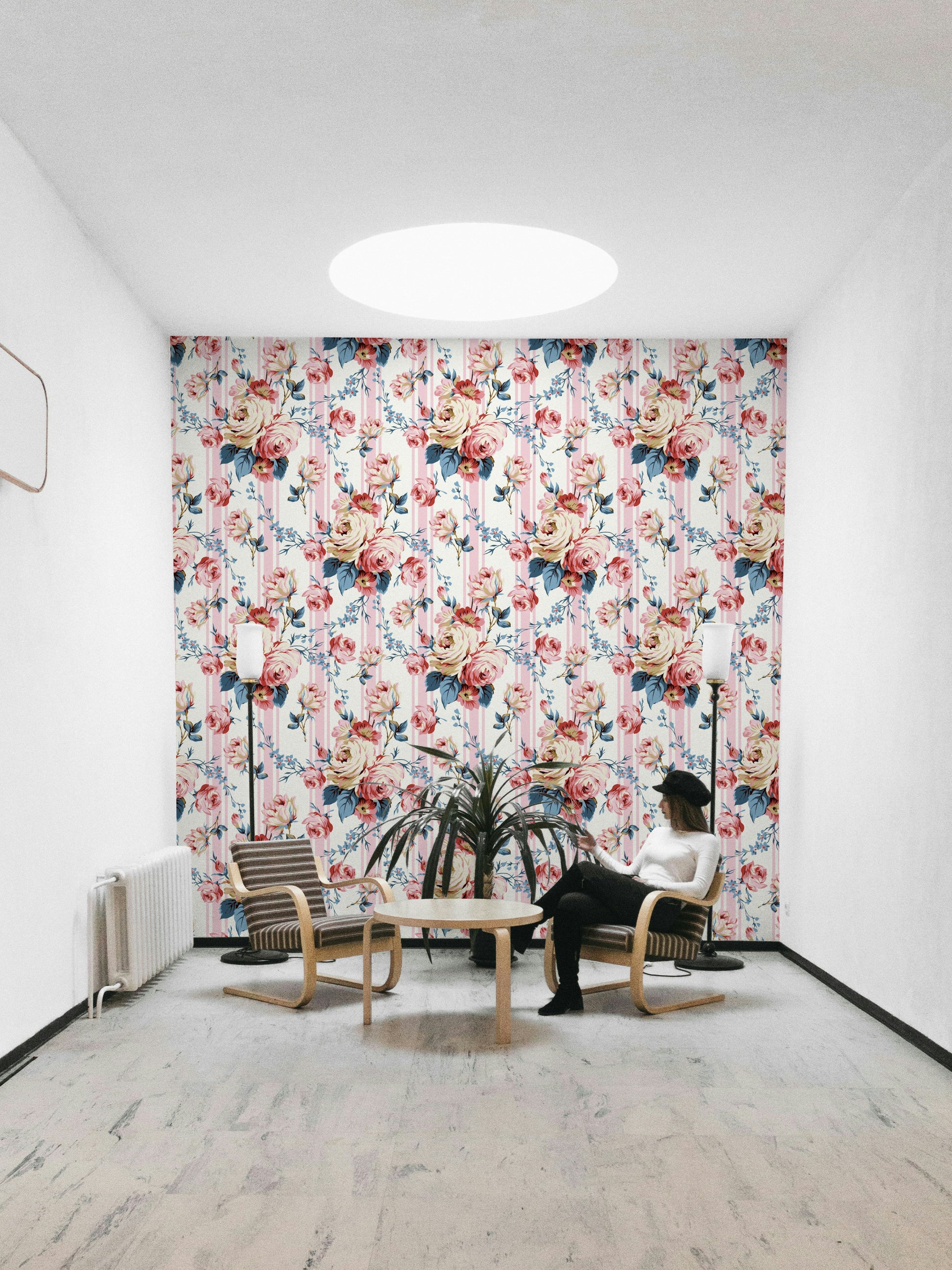 Close-up of pink roses and leaves on a blue and white striped base.

