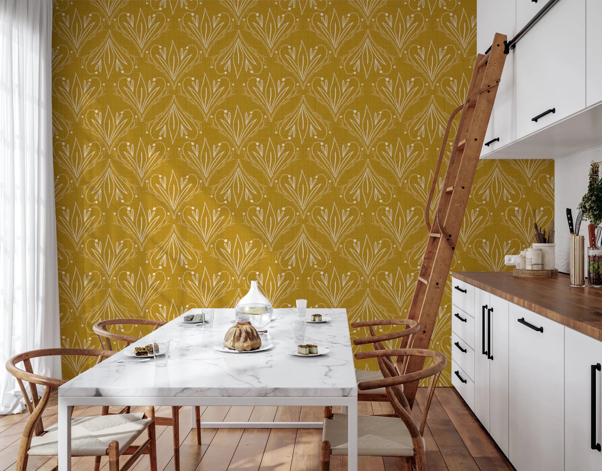 Boho Art Nouveau Folk Floral Mustard Gold wallpaper behind a marble dining table and wishbone chairs in a kitchen