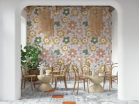 A boho blooms wallpaper featuring large retro-style flowers in muted green, mustard, and blush tones.