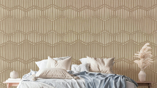 The mural is installed in a calm, bohemian living room behind a simple, light-colored sofa.

