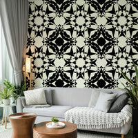 Intricate black and white wallpaper with star shapes.
