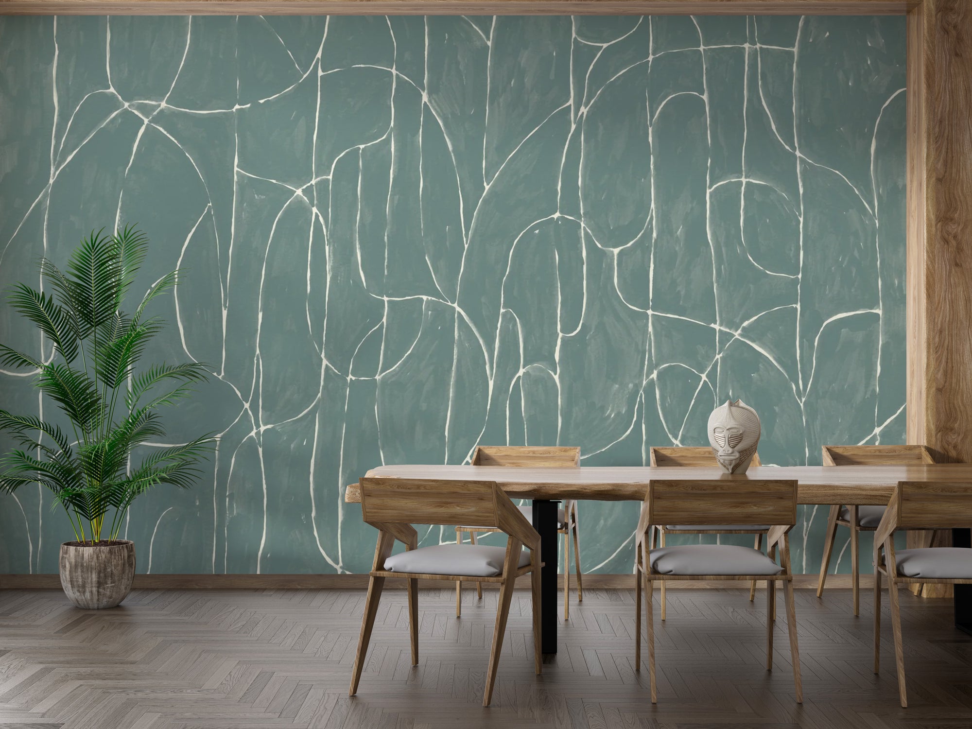 Boulder Beach Jade Blue wallpaper with abstract white lines behind a wooden dining table and potted palm