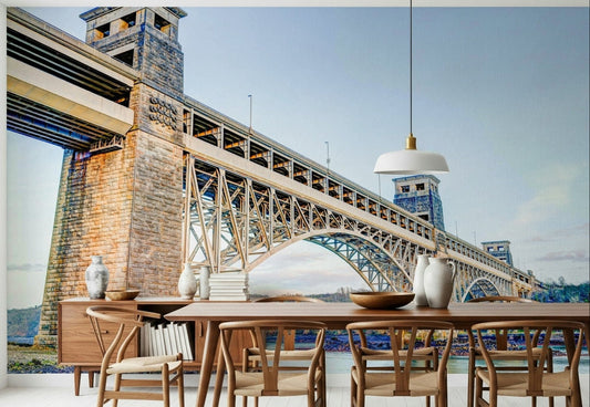 Britannia Bridge View wallpaper mural of a river bridge behind a wood dining table and wishbone chairs by a window