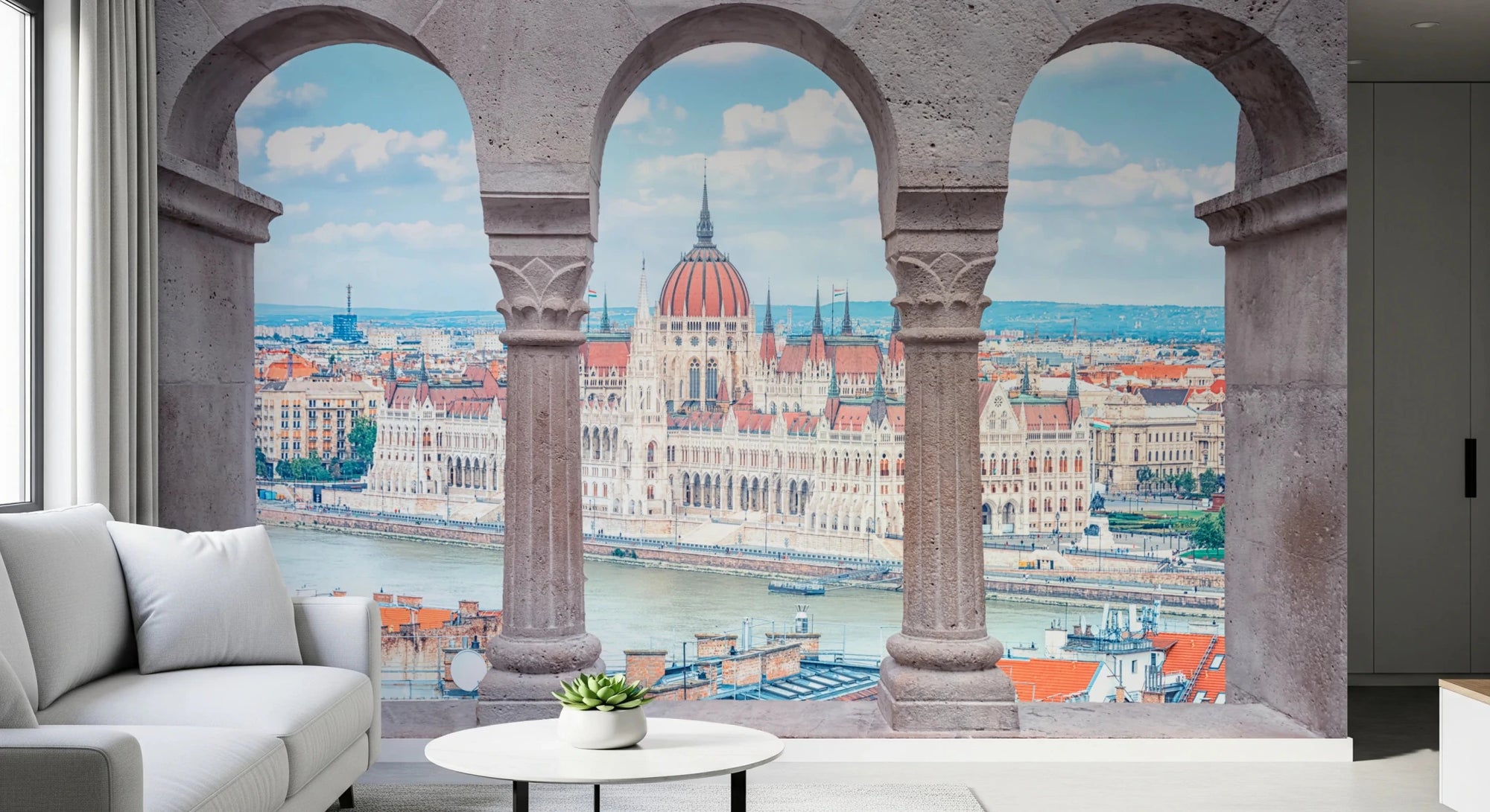Budapest Vista Arches wall mural of stone arches framing the Parliament and river behind a white sofa in a living room