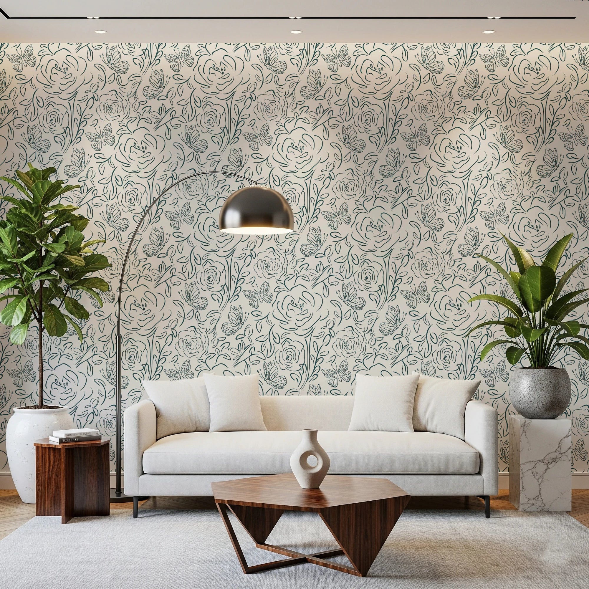 Butterfly Bloom Line Art wallpaper in teal roses behind a cream sofa with arc lamp and leafy plants