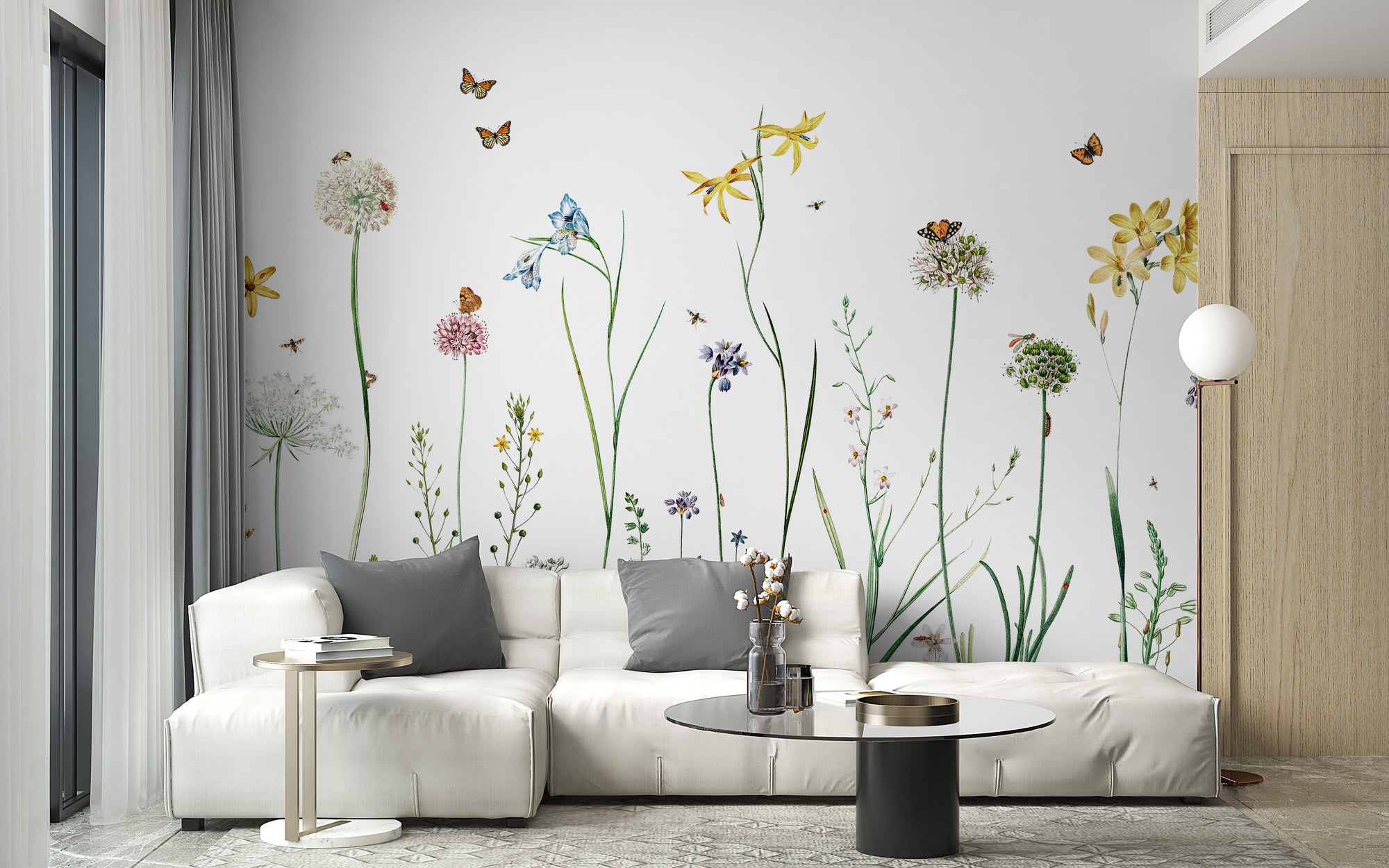 Butterfly Garden wallpaper mural of wildflowers and butterflies on white behind a white sectional sofa in a living room