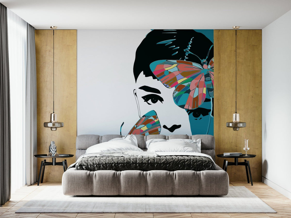 Butterfly Muse wall mural of a woman's face with colorful butterflies behind a grey bed in a bedroom