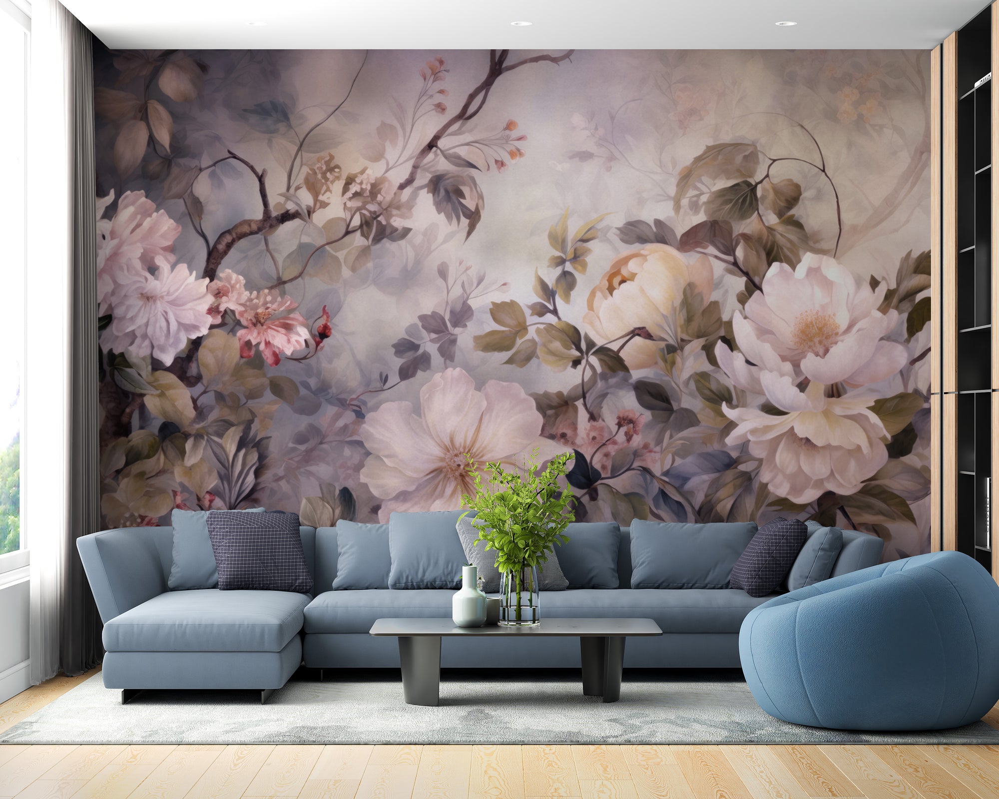 Barok Blossom Pink Color wallpaper with soft painterly peonies behind a blue sectional sofa in a living room