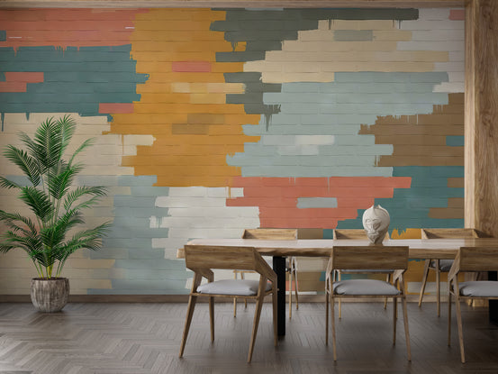 Painted Brick Illusion wallpaper mural in teal, orange and coral behind a wood dining table and potted palm