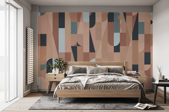 Chromatic Puzzle Wall mural in terracotta and navy geometric shapes behind a wooden bed in a bedroom