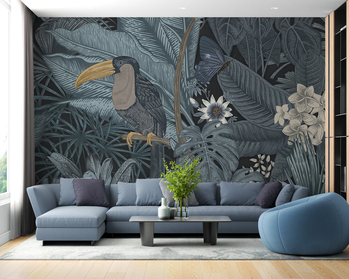 Tropical Toucan wall mural with a toucan among blue-grey jungle leaves above a blue sectional sofa in a living room