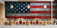 Cafe interior with a Rustic Steel American Flag Wall Mural on canvas texture and modern wooden stools.