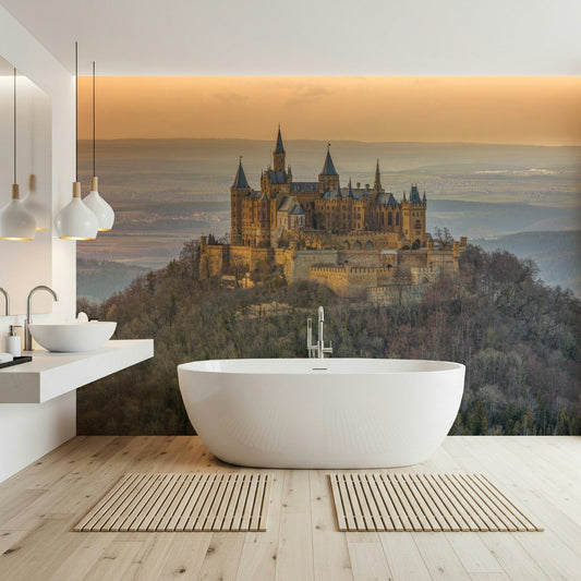 Castle Majesty wallpaper mural showing a spired castle over a misty valley beside a freestanding white tub in a bathroom