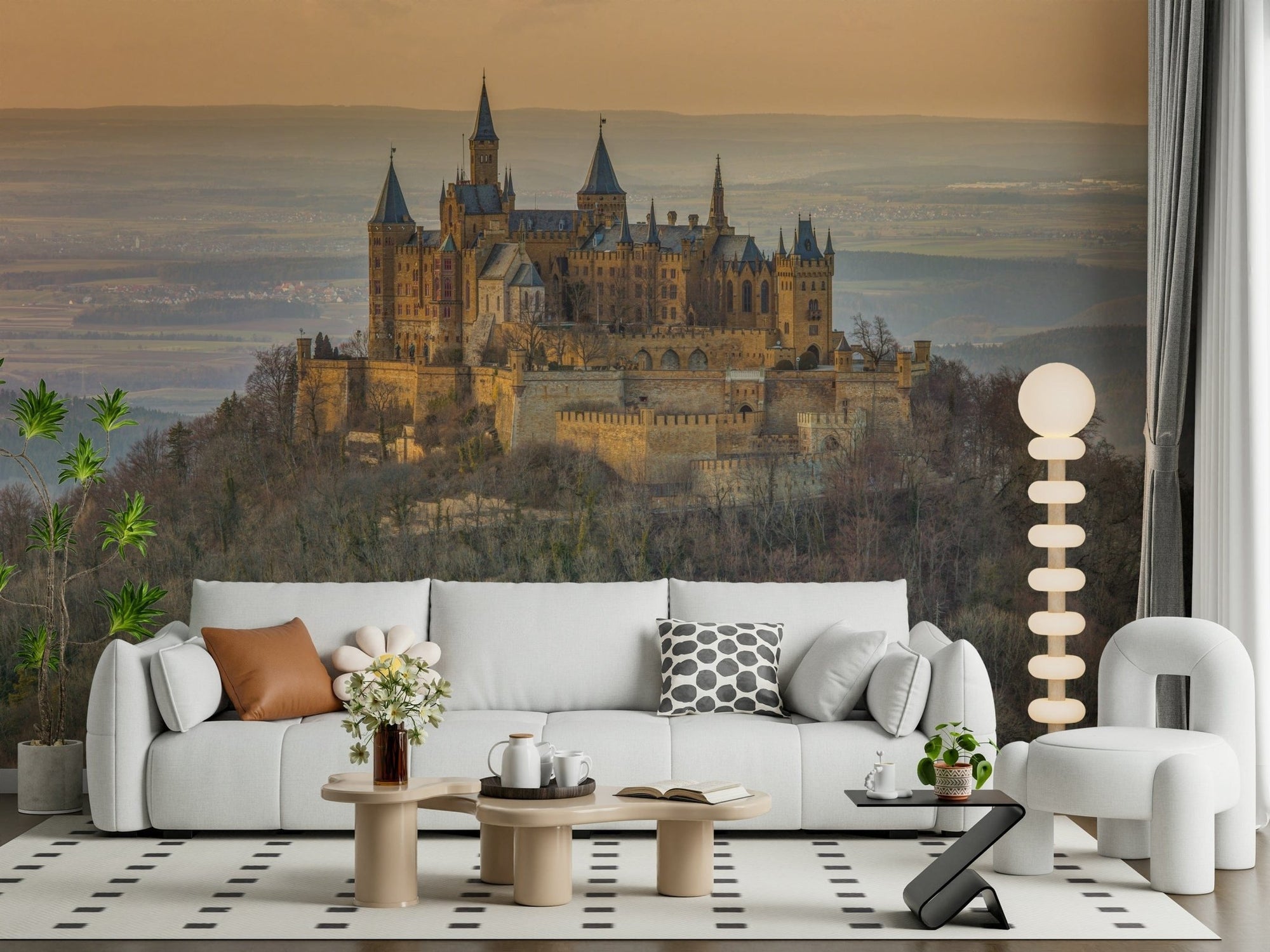 Castle Majesty wallpaper mural of a hilltop castle at sunset behind a white sofa in a bright living room