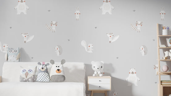 Forest Animals Gray wallpaper behind a white bed with owl and bear plush cushions in a grey kids room