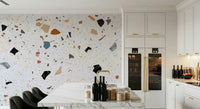 Large fleck terrazzo mural, geometric shapes on light surface.