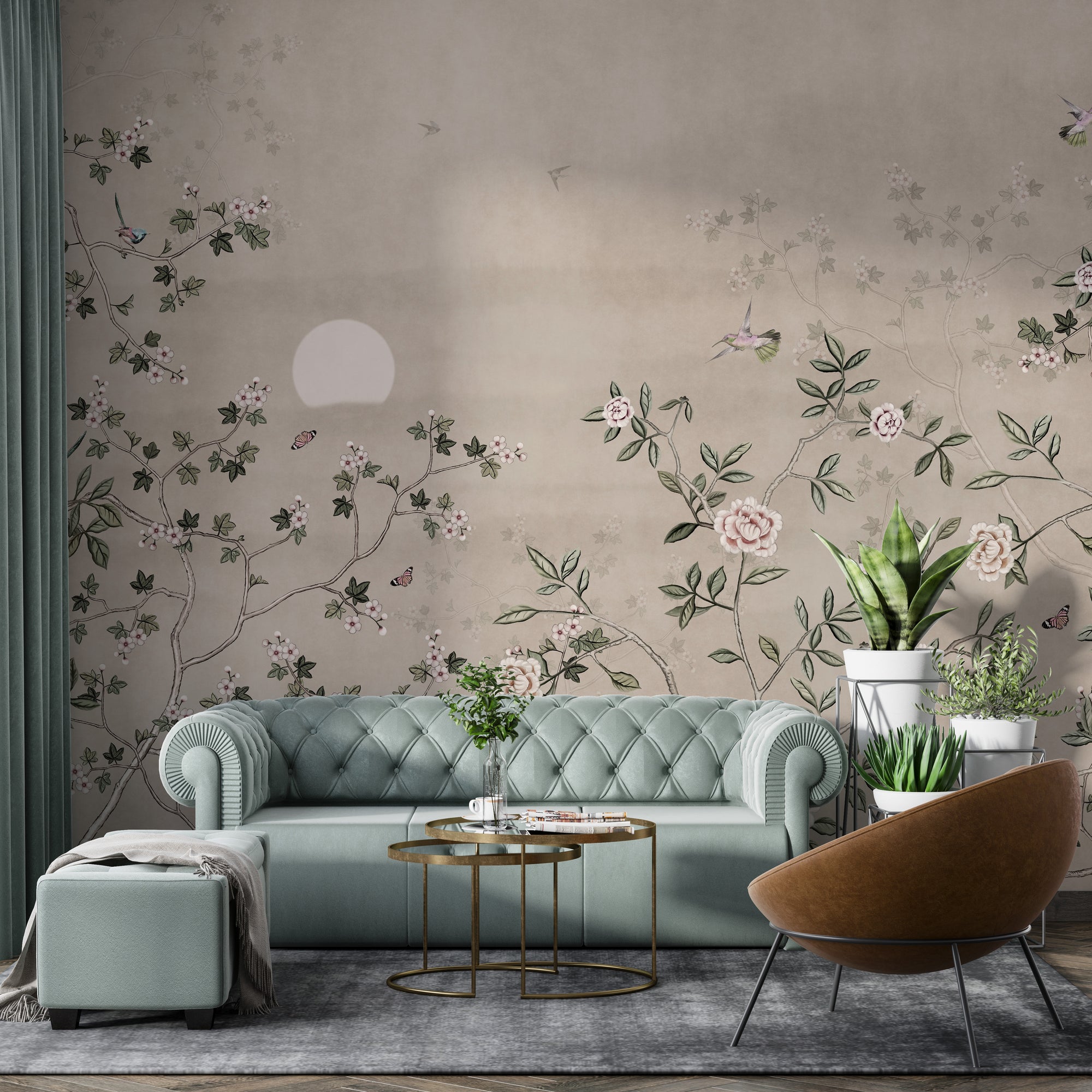 Chinoiserie Floral Botanical wallpaper mural with pink roses and birds behind a sage-green tufted sofa in a living room