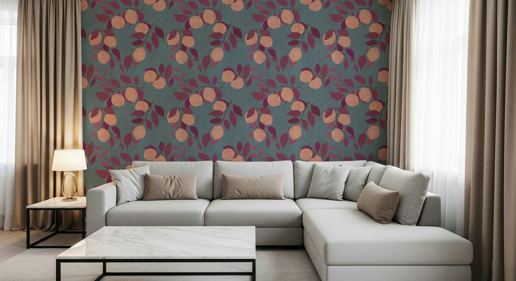 Citrus Bliss wallpaper with peach fruit and burgundy leaves on teal behind a grey sectional sofa