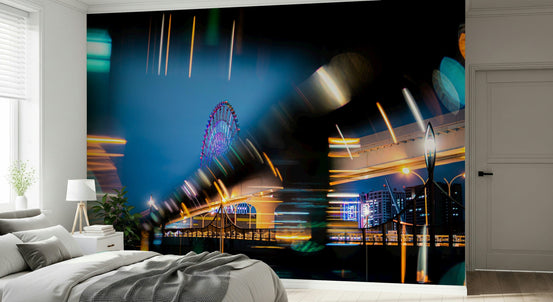 City Lights Fusion wallpaper mural of a neon Ferris wheel and light streaks in a bedroom with grey bedding