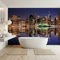 Night skyline reflection mural in entryway, modern city scene behind timber console