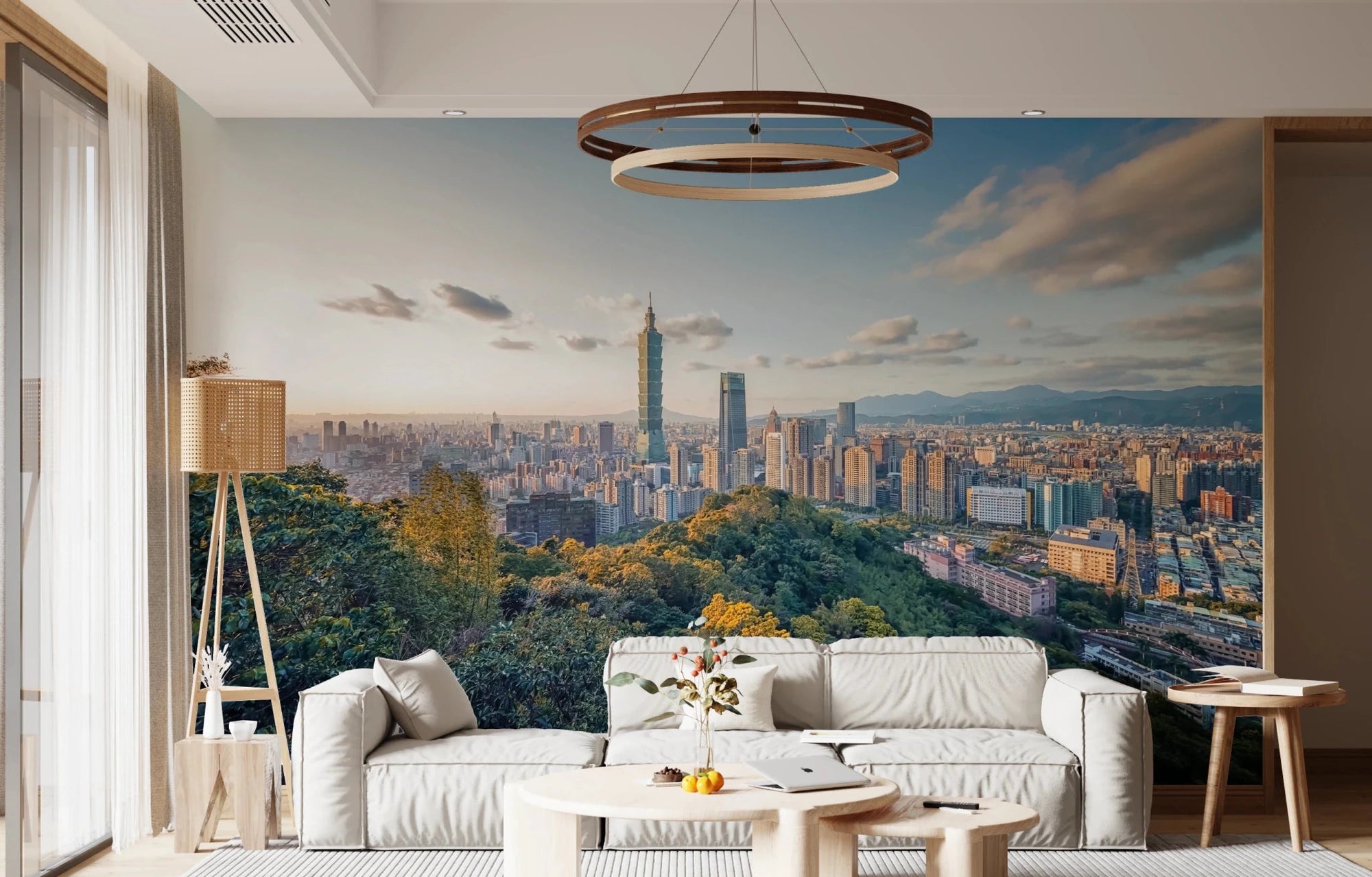 Cityscape Vista wallpaper mural of the Taipei 101 skyline at sunset above a white sofa and rattan floor lamp
