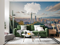 Cityscape Vista wallpaper mural of the Taipei skyline over hills above a grey sofa and black metal coffee table