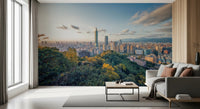 Cityscape Vista wallpaper mural of Taipei at sunset behind a beige sofa and black coffee table by tall windows