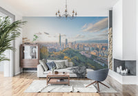 Cityscape Vista wallpaper mural of Taipei 101 at dusk behind a green velvet sofa and a tall cactus plant