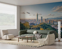 Cityscape Vista wallpaper mural of the Taipei skyline above a grey sofa with a walnut cabinet and chandelier