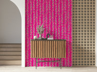 Colorful leaf designs arranged along upward vine stripes against a vivid fuchsia wallpaper background.