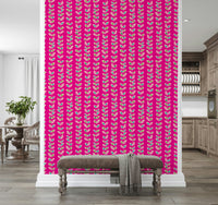 A lively fuchsia wallpaper decorated with vertical vines and multicolored retro-style leaves.