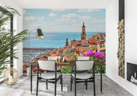 Historical bell tower overlooking a blue Mediterranean Village mural.