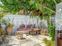 Colorful Backyard Patio Wall Mural featuring bright textiles and stone floor.