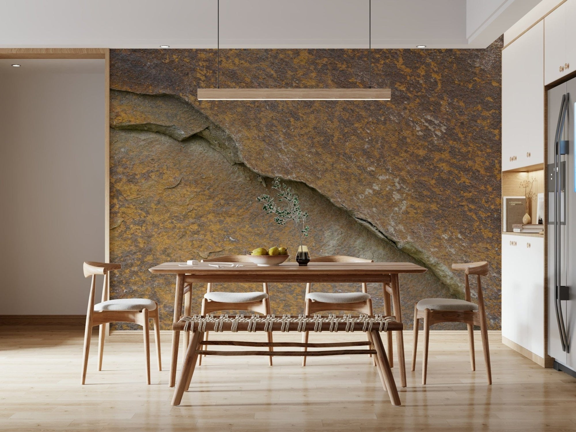 Cracked stone wallpaper mural in rusty orange behind a wooden dining table and bench in a dining room