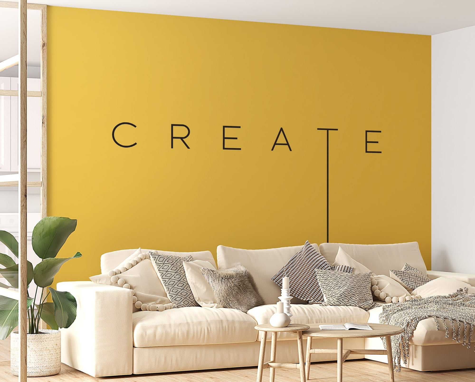 Creative Vision wallpaper mural with CREATE text on a yellow wall behind a cream sectional sofa in a living room