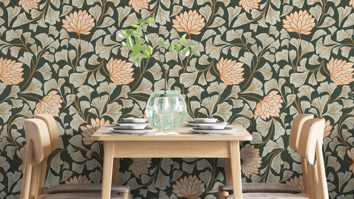 Dancing Bloom Dark wallpaper in olive green with peach blooms behind a wood dining table and glass vase