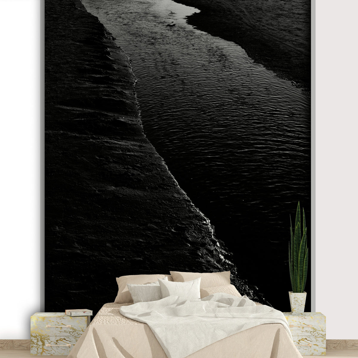 Dark River I wallpaper mural in black and white above a tan bed and snake plant in a moody bedroom