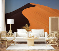 Neutral nursery accent wall with desert mural, soft dune shapes, calm living space feel