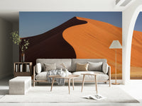 Home office feature wall with desert dune mural, warm neutral colours, clean modern setup