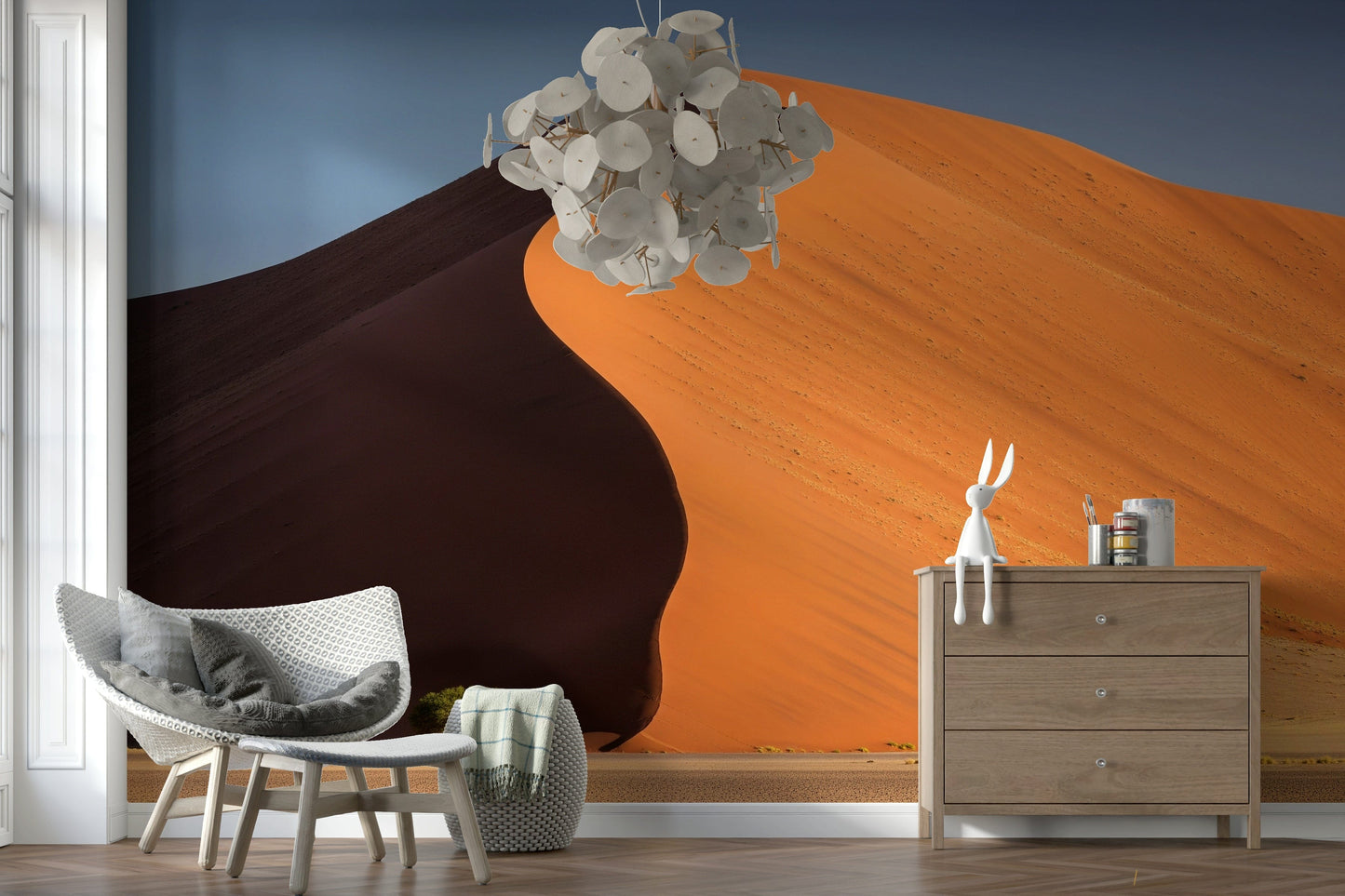 Living space feature wall showing desert dunes mural, soft light, natural textures and timber