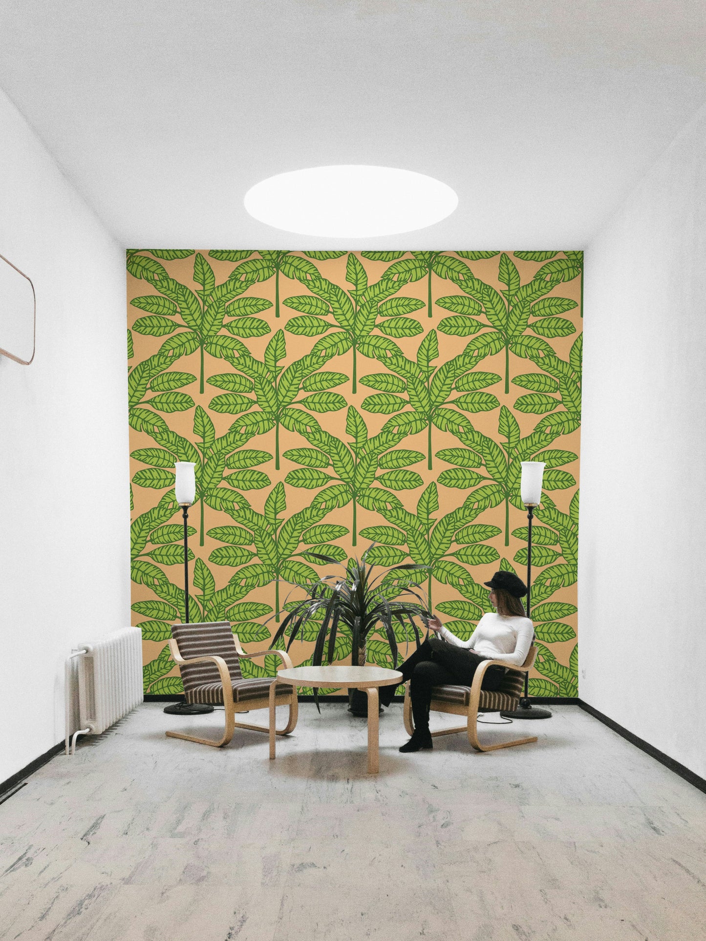 Bright and bold tropical leaves design in green and orange tones on wallpaper.

