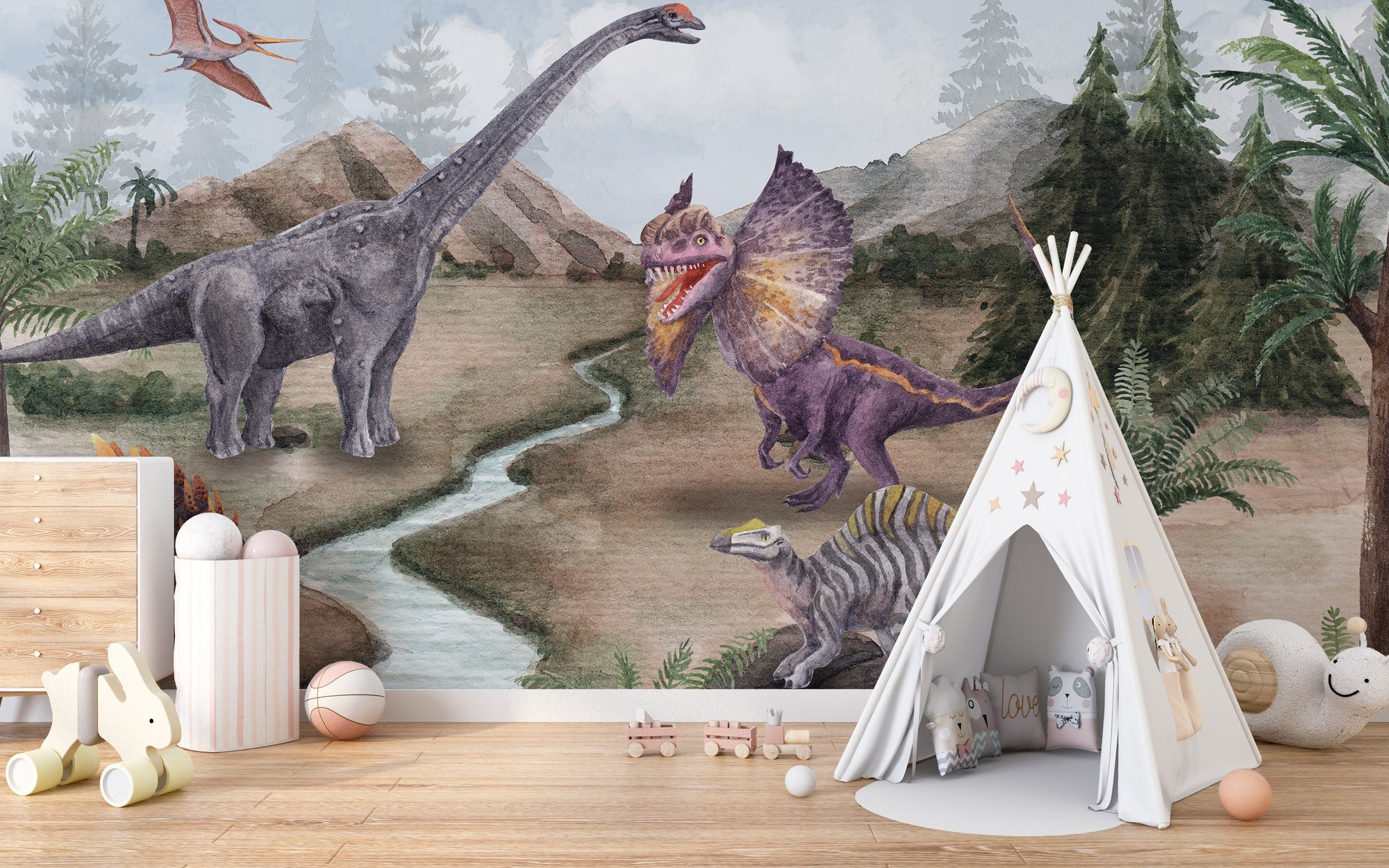 Dinosaur Era wallpaper mural with watercolour dinosaurs by a river and mountains behind a white teepee tent in a kids room