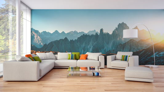 Dolomites Alps Rocky Mountain Range wallpaper mural behind a white sectional sofa in a bright living room