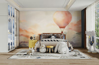 Hot air balloon wall art in a sun-drenched master bedroom.