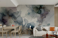 Large scale floral mural behind a light gray sofa in an apartment.